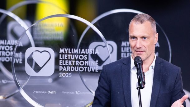 Vyras kalba prie mikrofono šalia apdovanojimo „Mylimiausia Lietuvos elektroninė parduotuvė“